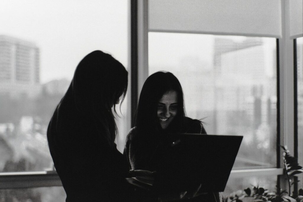 Two women looking at a laptop screen